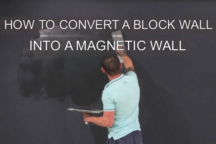 A man plastering a block wall with magnetic plaster using a plastering trowel