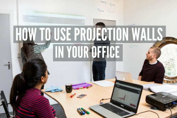 Office team presentation on projector whiteboard wallcovering wall