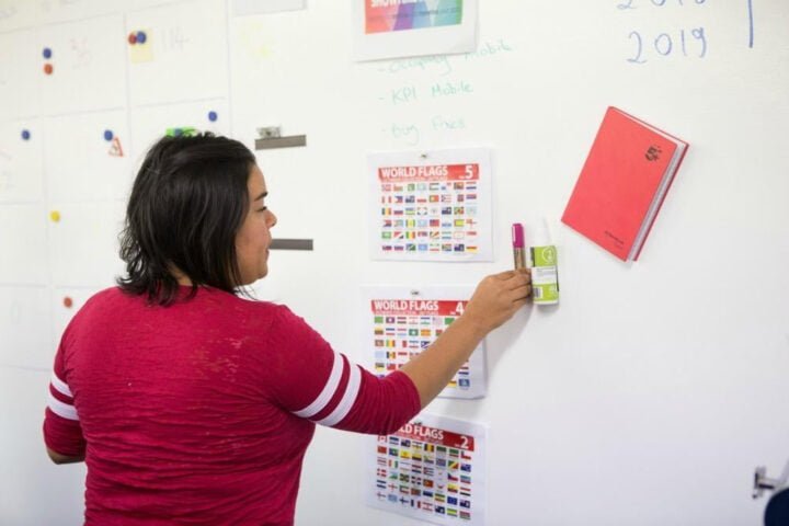 Woman using super magnetic painted wall
