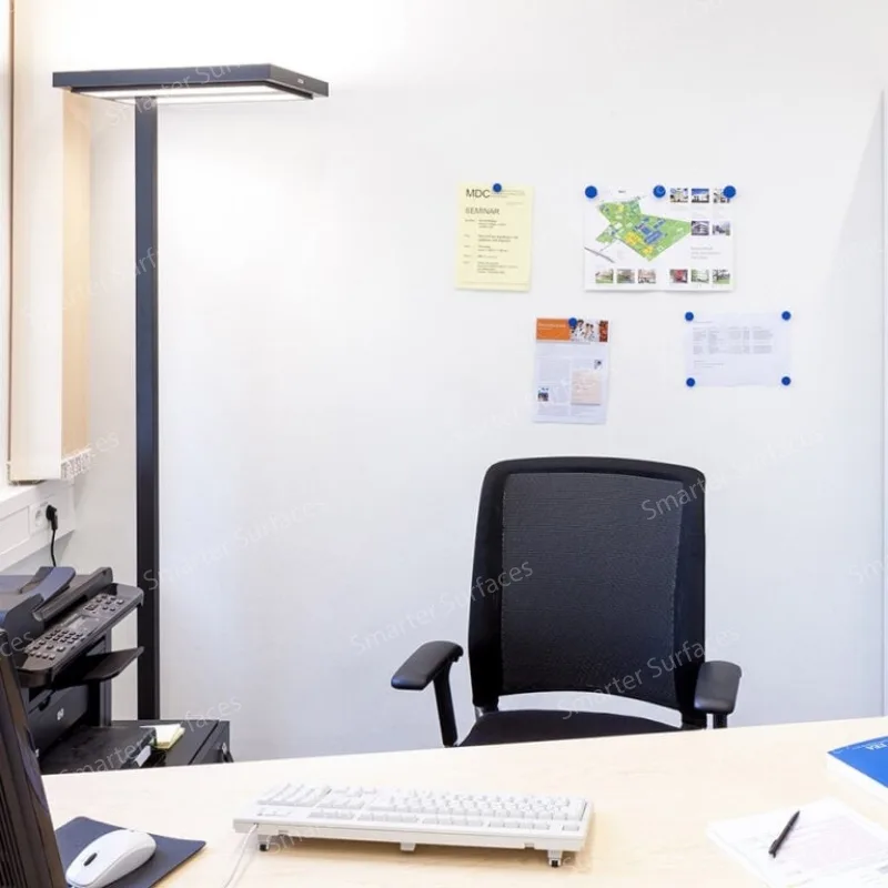 Clean modern home office workspace with Smarter Surfaces DIY Magnetic Paint displaying documents, notes, and infographics attached with magnets.