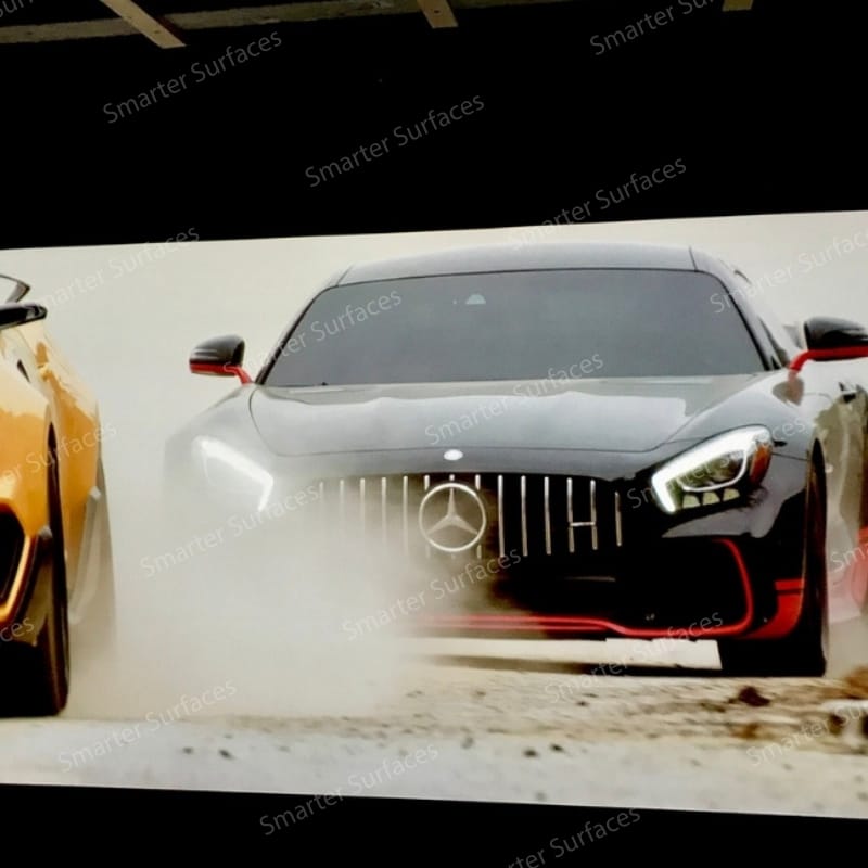 Home theatre setup projecting a movie onto a black painted wall