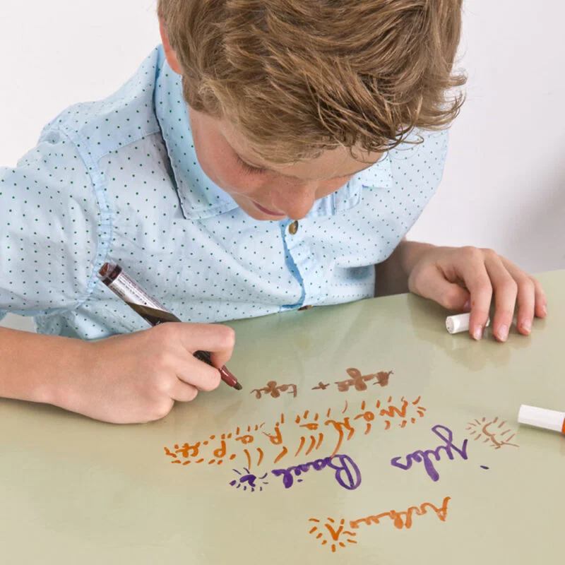 Children using whiteboard marker on clear whiteboard paint table