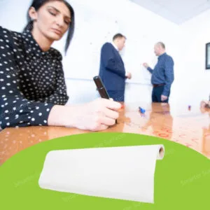 Team writing on a table surface covered with clear whiteboard film