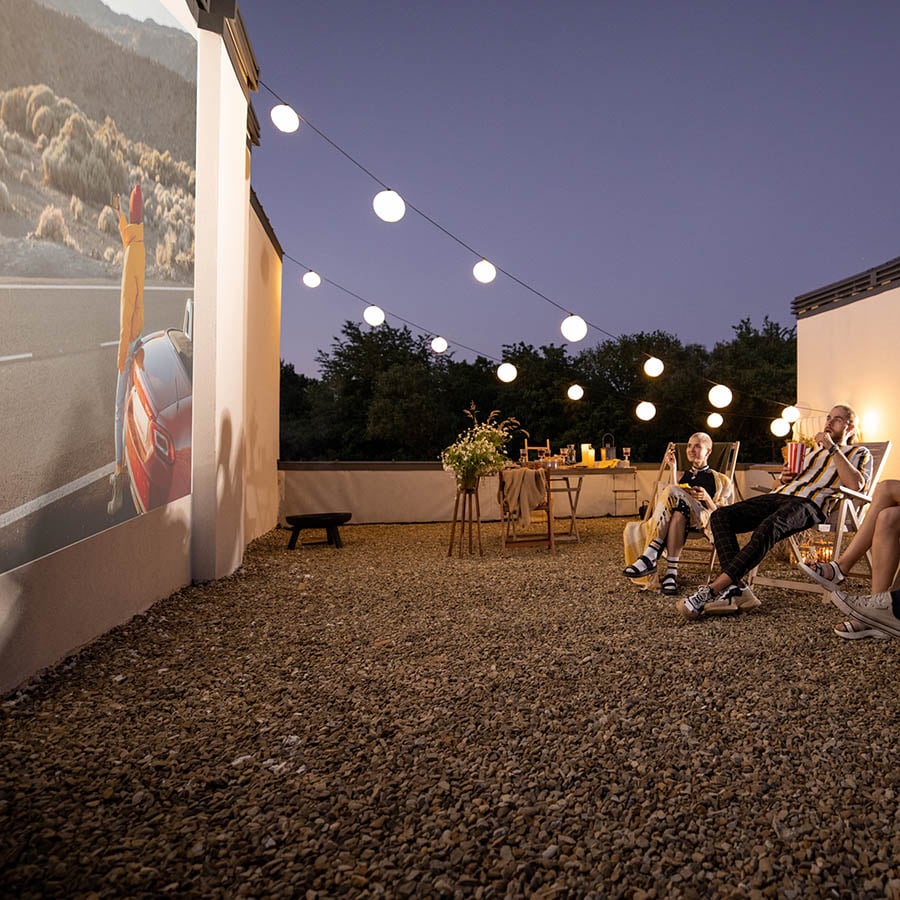 Enjoy watching videos on outdoor projector screen paint rooftop