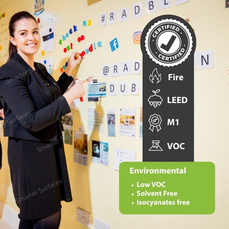 Professional woman presenting environmental product certifications including Fire safety, LEED certification, M1 emissions testing, and VOC compliance with certified badge highlighting low VOC, solvent-free, and isocyanate-free features