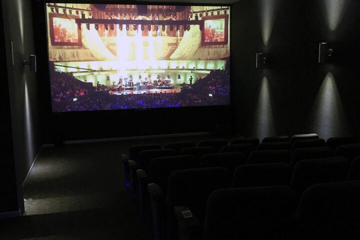 Movie projected onto a wall with ultra-high-contrast projector screen paint in a home theater