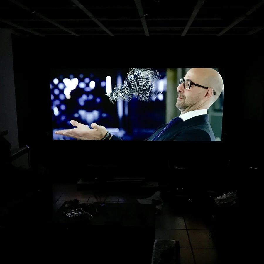 Movie projected onto a wall with ultra high contrast projector screen paint in a home theater