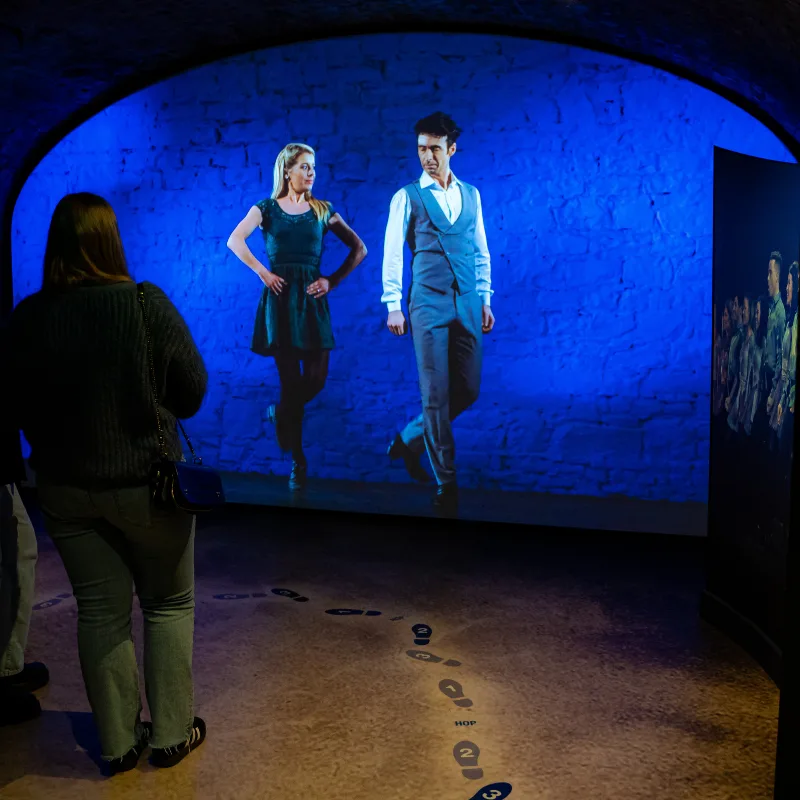 Visitors watching a performance on an invisible projector screen