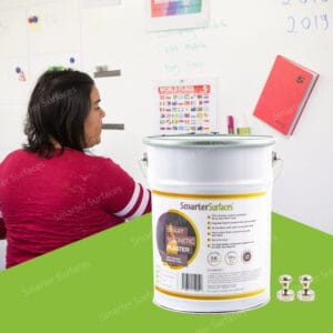 Woman working with magnetic plaster wall displaying colorful notes and calendar on magnetic receptive surface