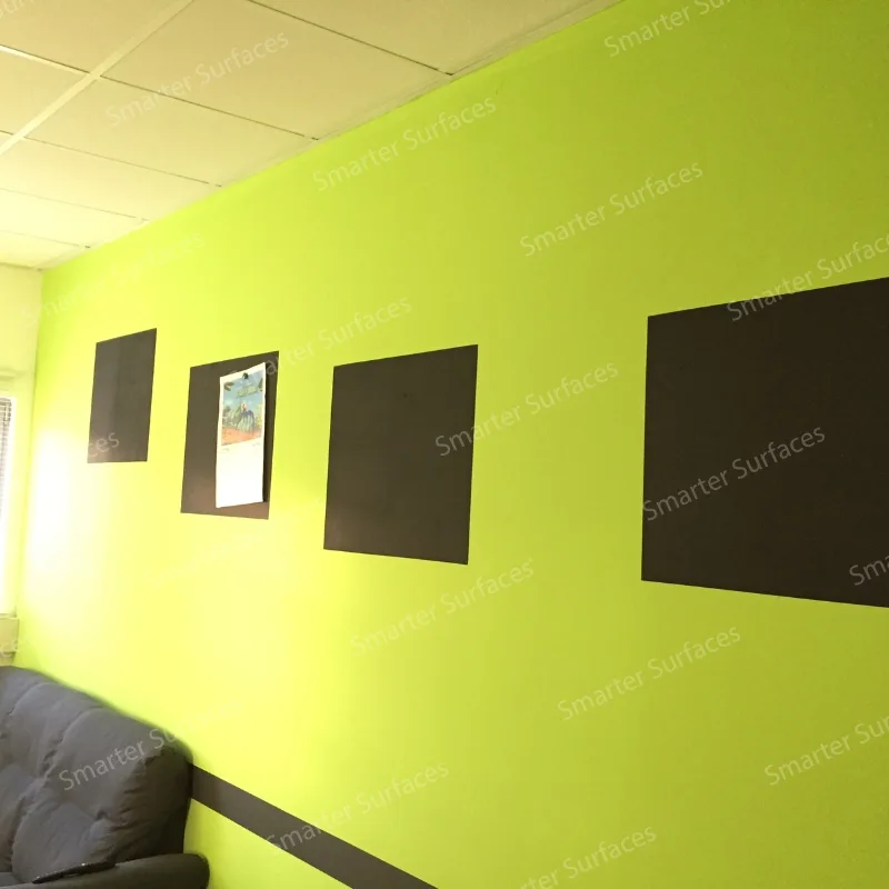 Interior hallway featuring bright yellow-green magnetic walls with three dark magnetic panels displaying artwork and documents