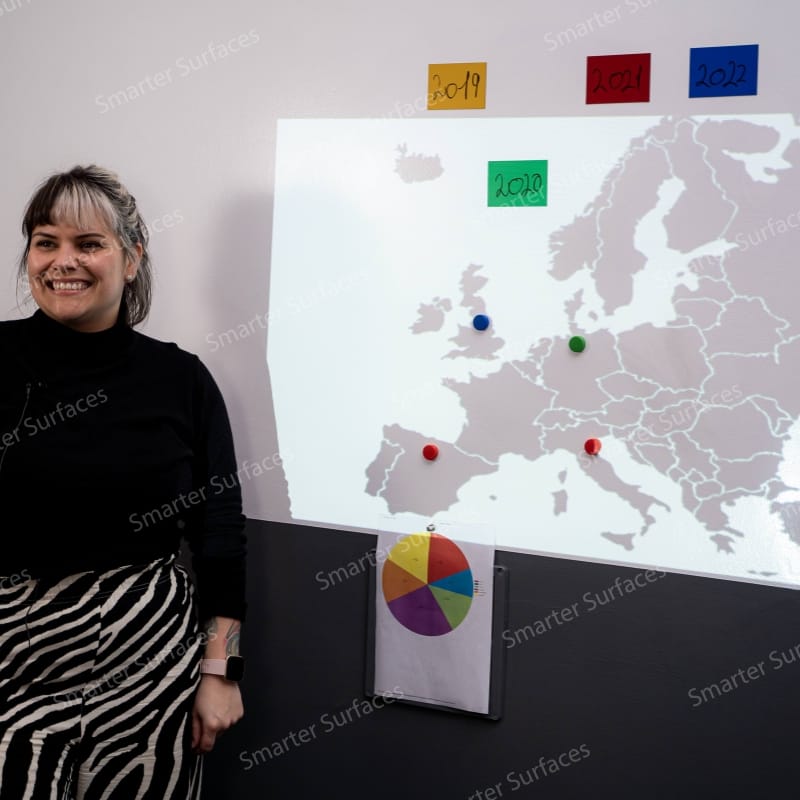 Teacher presenting a map using magnetic projector wallpaper in a classroom
