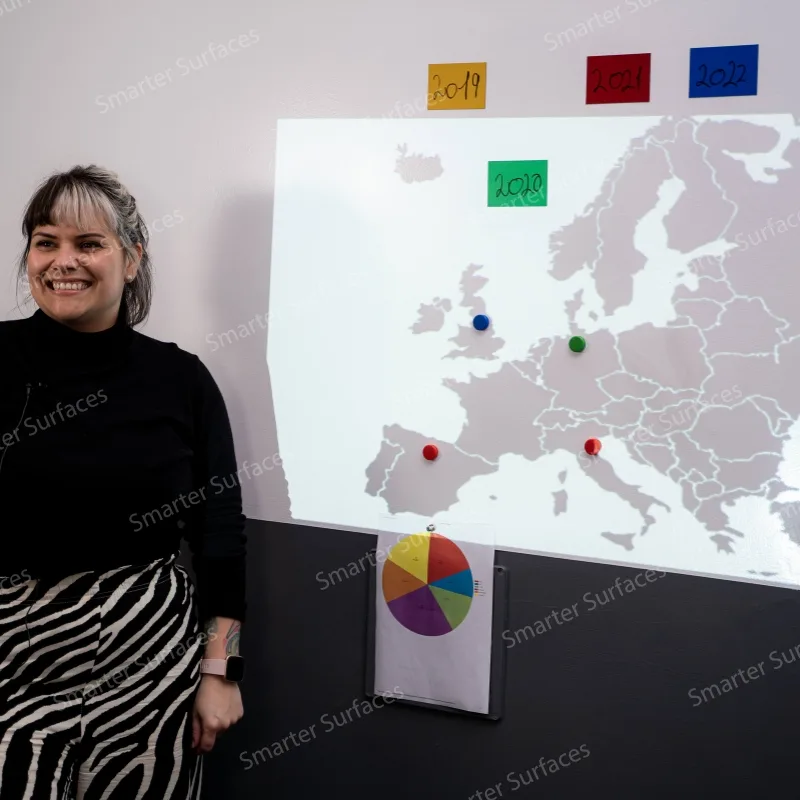 Teacher presenting a map using magnetic projector wallpaper in a classroom