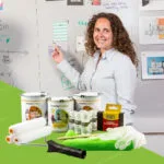 Smiling woman presenting ideas on a wall coated with Smarter Surfaces magnetic whiteboard paint clear