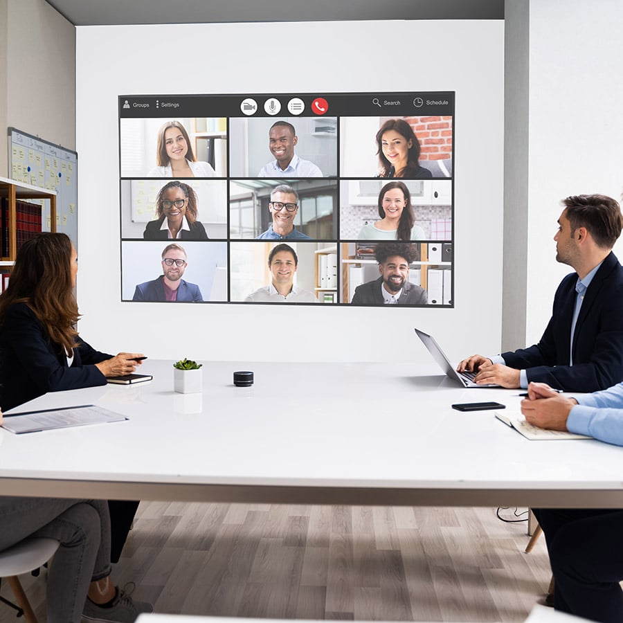 Modern Office Design Trends with office video call projected on projector screen paint wall