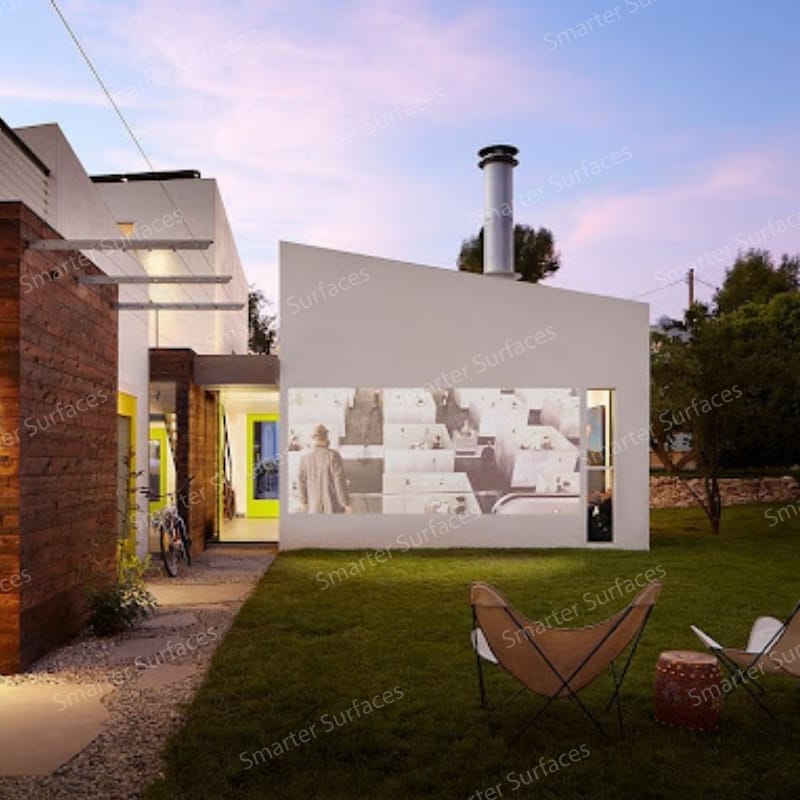 Modern house exterior displaying a projection made with outdoor projector screen paint