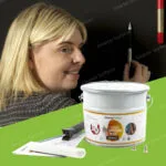 Woman applying Super Magnetic Paint on a wall using Smarter Surfaces strong magnetic wall kit