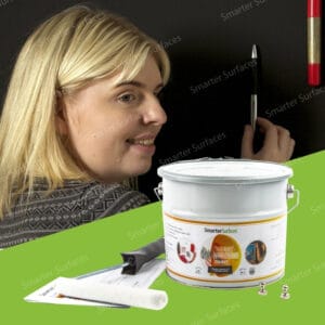 Woman applying Super Magnetic Paint on a wall using Smarter Surfaces strong magnetic wall kit