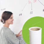 Woman writing on white dry erase wall covering with colorful markers