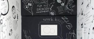 Creative doodles and notes drawn on a magnetic chalkboard wall.