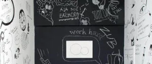 Creative doodles and notes drawn on a magnetic chalkboard wall.