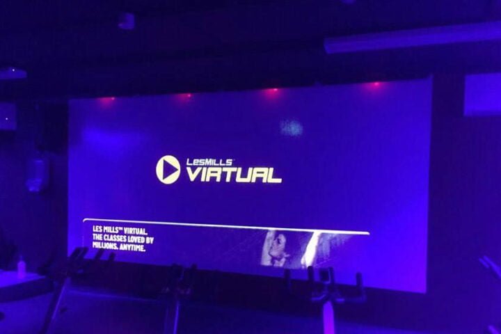 A Video is playing on big projector screen in blue light