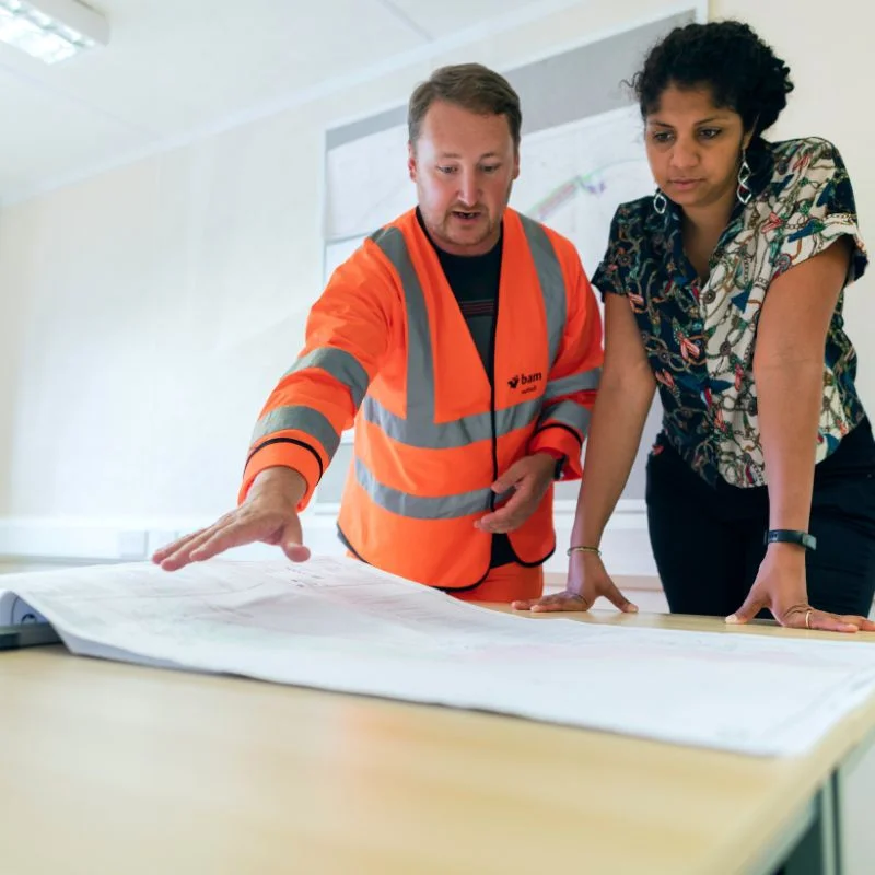 contractors reviewing office construction plans