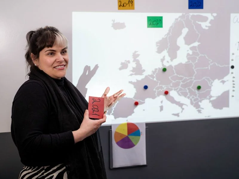 Teacher delivering lesson with Magnetic Gray Paint and Whiteboard Paint applied to wall
