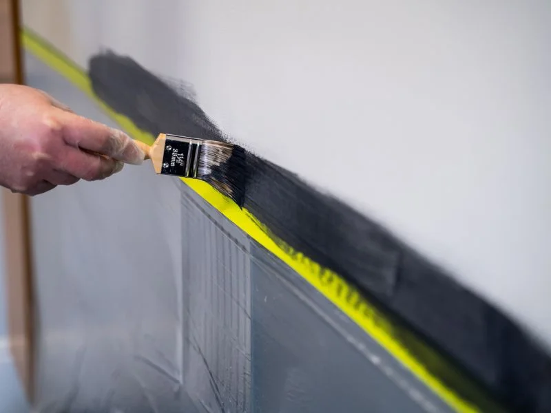Step 9 - Man applying magnetic gray paint with brush