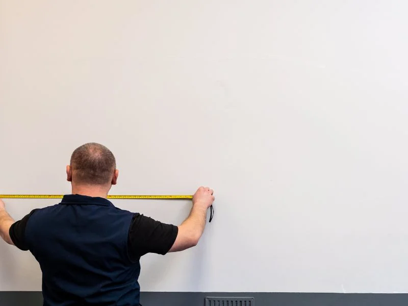 Step 1 - Man measuring area for magnetic gray paint
