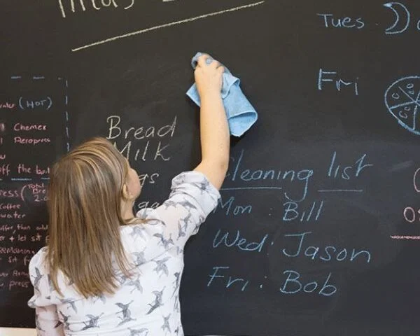 woman using smart surfaces chalkboard paint and microfiber cloth